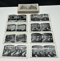 Top view showing a deck of stacked stereoview cards with visible black and white paired images including Eaton's store and workers at work, arranged in rows for display.