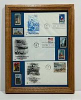 Full view of the framed postal memorabilia including all covers and stamps.