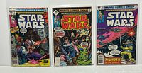 Overview photo showing three Marvel Star Wars comics in protective sleeves: Issue #7, #9, and #34 with distinct colorful covers featuring characters and space scenes.