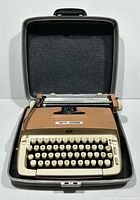 Vintage Smith Corona Galaxie manual typewriter inside open black carrying case, showing keyboard and typewriter shape.