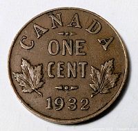 Reverse side of the 1932 Canadian one cent coin showing denomination, date, and maple leaves.