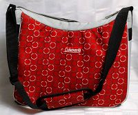 Front and close-up view of red Coleman cooler bag with circular pattern and shoulder strap.