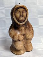 Front view of the candle showing the full figure holding a child