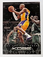 Kobe Bryant basketball card showing Kobe in Lakers uniform during a game against Boston Celtics, with Panini logo visible.
