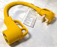 Yellow Kohree RV electrical adapter cable with 30 amp female and 50 amp male plugs, showing label and grips