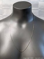 Photo showing the sterling silver necklace on a mannequin bust to display length and appearance.