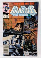 Front cover of The Punisher #2 comic book showing the Punisher holding a submachine gun, with several antagonists in the background, issued by Marvel Comics in 1986.