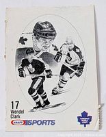 Front of black and white Wendel Clark hockey card showing three illustrations of player in Toronto Maple Leafs uniform with logos and number 17