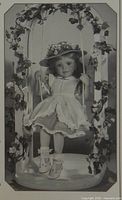 Promotional black-and-white photo of Lindsey doll seated on swing