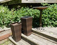 Birdbath and two planters together outdoors