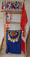 Large Canada flag on pole, Oshawa flag folded, mini flags above