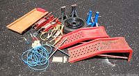 overall view showing creeper, bottle jacks, jack stands, wheel, ramps, cables, tools