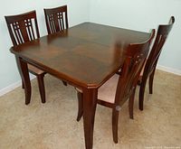 Overall view of wood dining table with four matching chairs