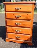 Front view showing five drawers and brass pulls