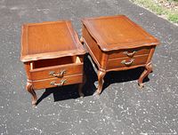 pair of matching wood end tables, one drawer open