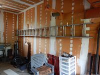 Full view of aluminum extension ladder mounted on wall