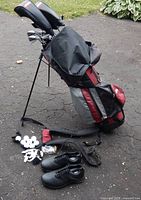 Full view of stand bag with clubs, shoes, balls, tees, glove, sunglasses