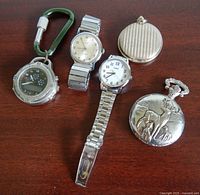 Group shot of all five watches on table