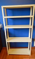 Front view of metal shelving unit showing five shelves