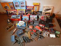 Overall lot showing boxed kits, assembled buildings and loose parts
