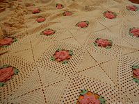 Close-up of crocheted bed cover showing 3-D rose motif