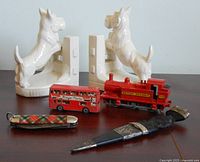 All items group view: bookends, dagger in sheath, multi-tool closed, double-decker bus, locomotive