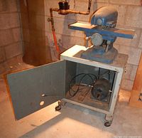 Planer on open cabinet stand showing interior motor