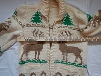 Front view of sweater coat with ruler across chest