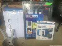 Lot items displayed including boxed Screen Pet Door, boxed Access Door cover, and unboxed Lucky Box litter scoop.