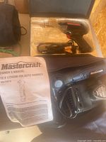 Mastercraft 12V Lithium-ion Auto Hammer with owner's manual and carrying case shown inside the case.