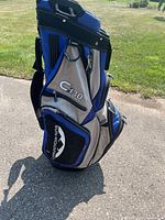 Side view of the blue and gray Sun Mountain C130 golf bag showing multiple zippered pockets and logo.