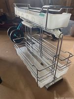 Front and side view of the multi-tier under the sink organizer rack showing metal frame and plastic trays.