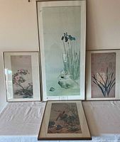 Four framed vintage Japanese prints arranged, three matching frames 21" x 14.5" and one tall 39" x 18" with text at bottom.