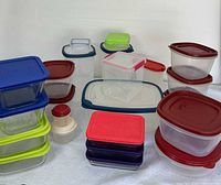 Overview showing the mix of glass and plastic food storage containers with lids in various colors