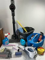 Overview of all items including LG stick vacuum, mop bucket, caddy, handheld vacuum and cleaning supplies