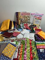 Overview of all fabrics, books, templates and pattern sheets arranged on table