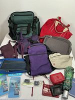 Wide view of the travel bags and accessories showing variety of items including backpacks, tote bags, fanny packs and pouches