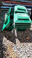 Stack of four green metal roof vents with two additional vents on side
