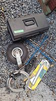 Overall view showing toolbox, trailer wheel, lug wrenches, cable, hose and packaged bilge pump