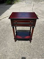 Front and top view of wooden end table with one drawer and lower shelf on casters.