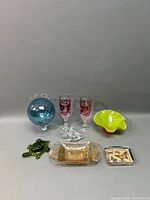 Full view of the lot showing all colored glass items including vase, glasses, and dishes