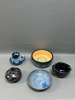 Full view of all five pottery pieces on display.