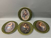 Four Pickard China plates with mother and child portraits, arranged against neutral background.