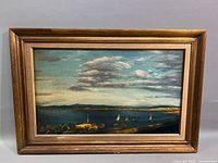 Frontal view of the seascape oil painting in its gold multi-layered frame.