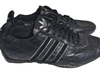 Lateral side view of both shoes showing leather uppers, silver stripes, Goodyear branding