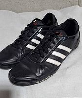 Oblique view of both shoes showing uppers and stripes