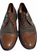 Front view of the pair showing leather cap toes and canvas uppers