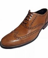 Side view single shoe showing leather, brogue pattern, lace-up
