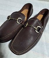 Top view of both loafers showing horsebit hardware and leather texture
