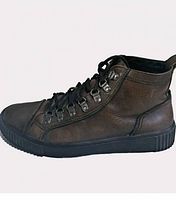 Left side view showing brown leather upper, metal eyelets, black sole